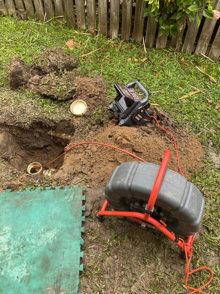 Man is Kneeling on the Floor Working on Pipes — Bay City Plumbing in Sunshine Acres, QLD