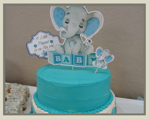 Blue baby shower cake topped with elephant topper and “BABY” blocks