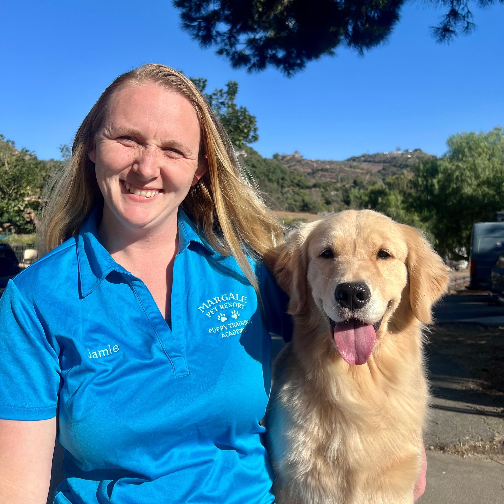 A woman in a blue shirt is standing next to a dog A woman in a blue shirt is standing next to a dog