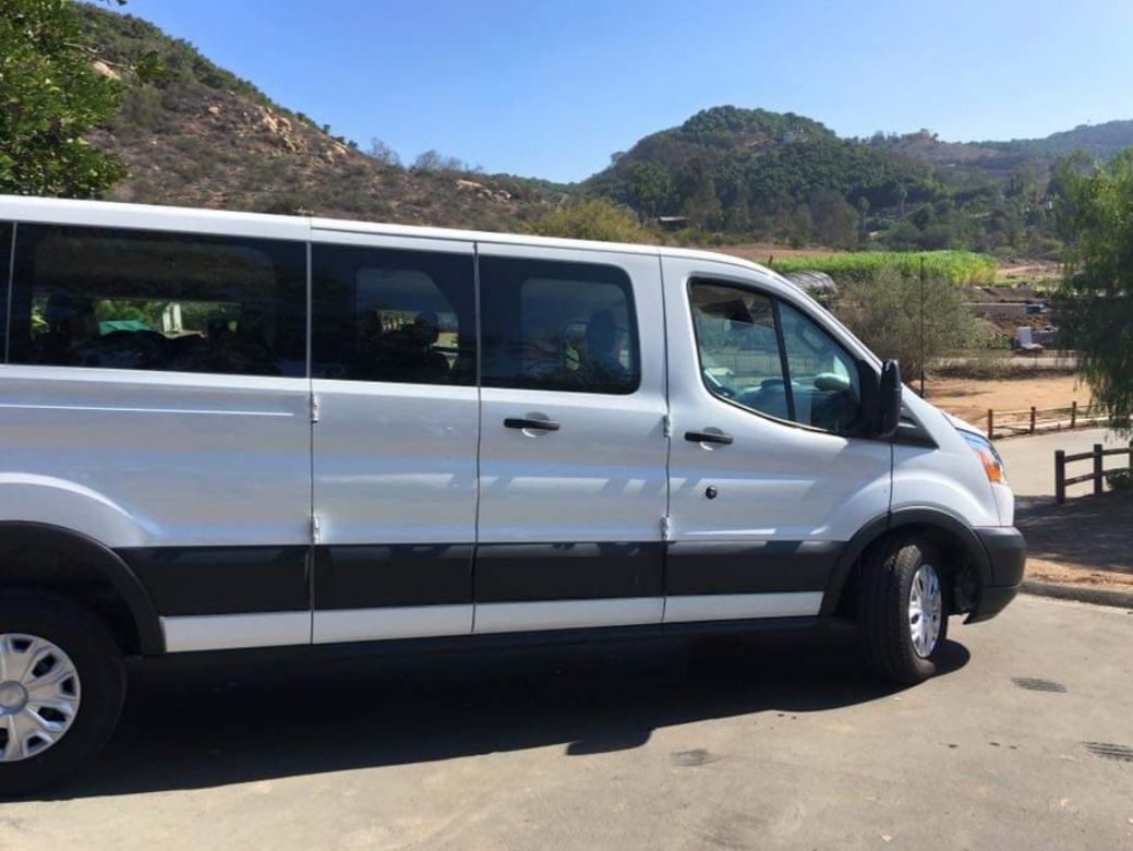 A white van is parked on the side of the road.