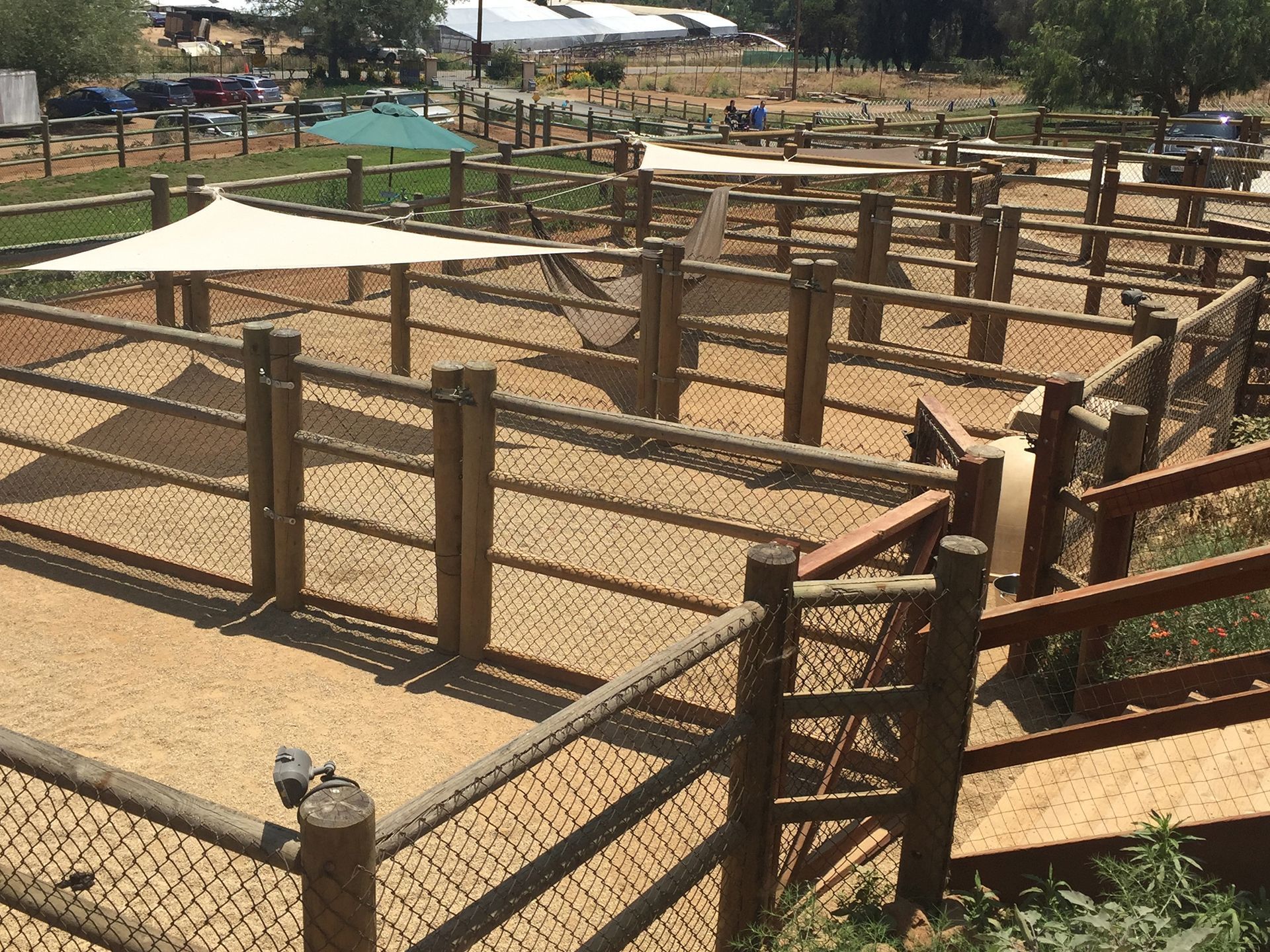 A wooden fence with a shade sail on top of it