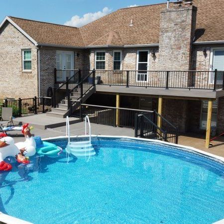A large house with a swimming pool in front of it