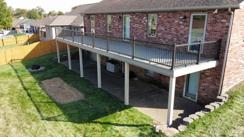 An aerial view of a house with a large deck.