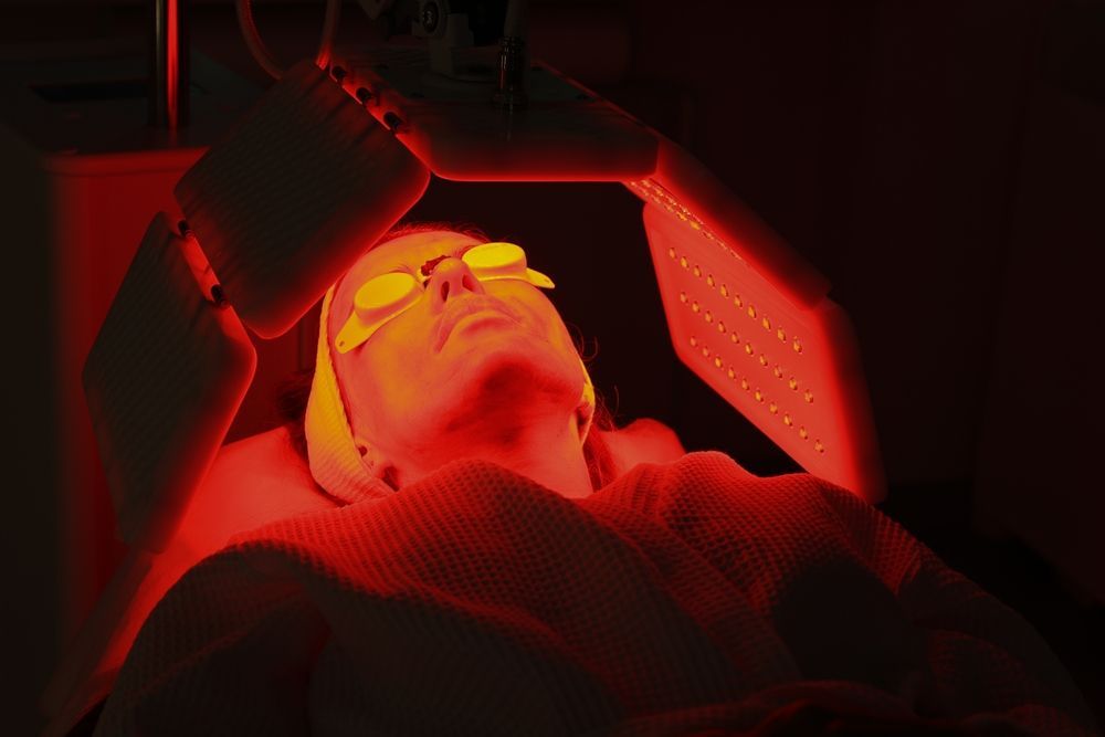 A Woman is Getting a Red Light Treatment on Her Face — Organic Beauty by Kessie in Yeppoon, QLD