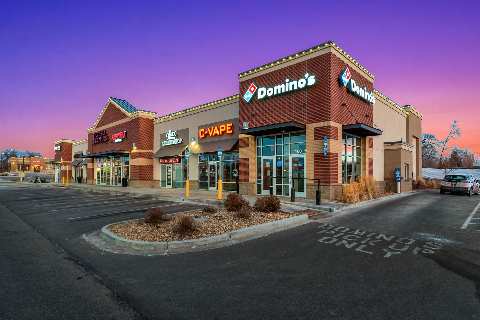 A domino 's pizza restaurant is located in a shopping center.