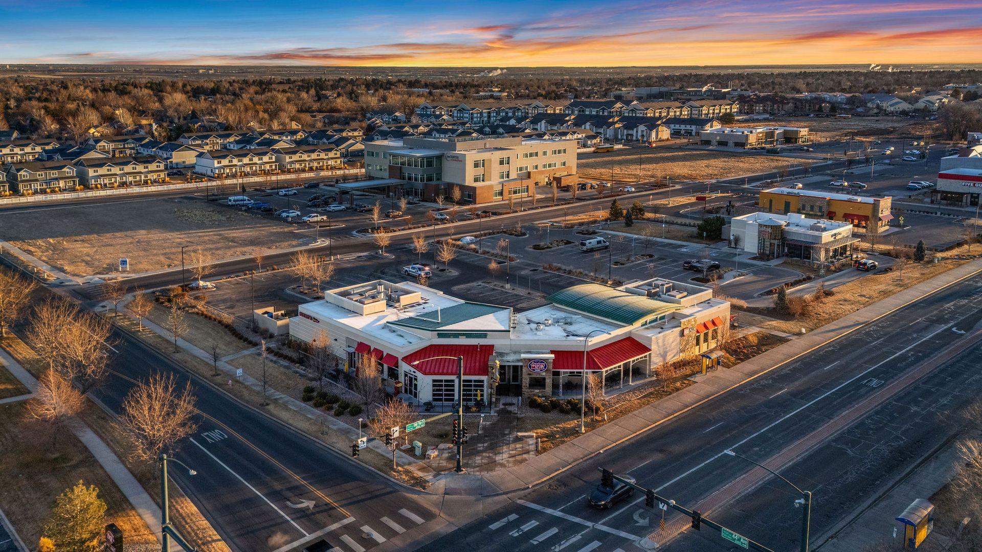 An aerial view of a large building in the middle of a city.
