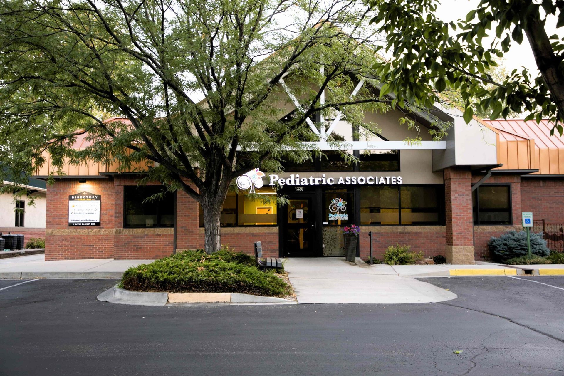 A brick building with a sign that says pediatric associates