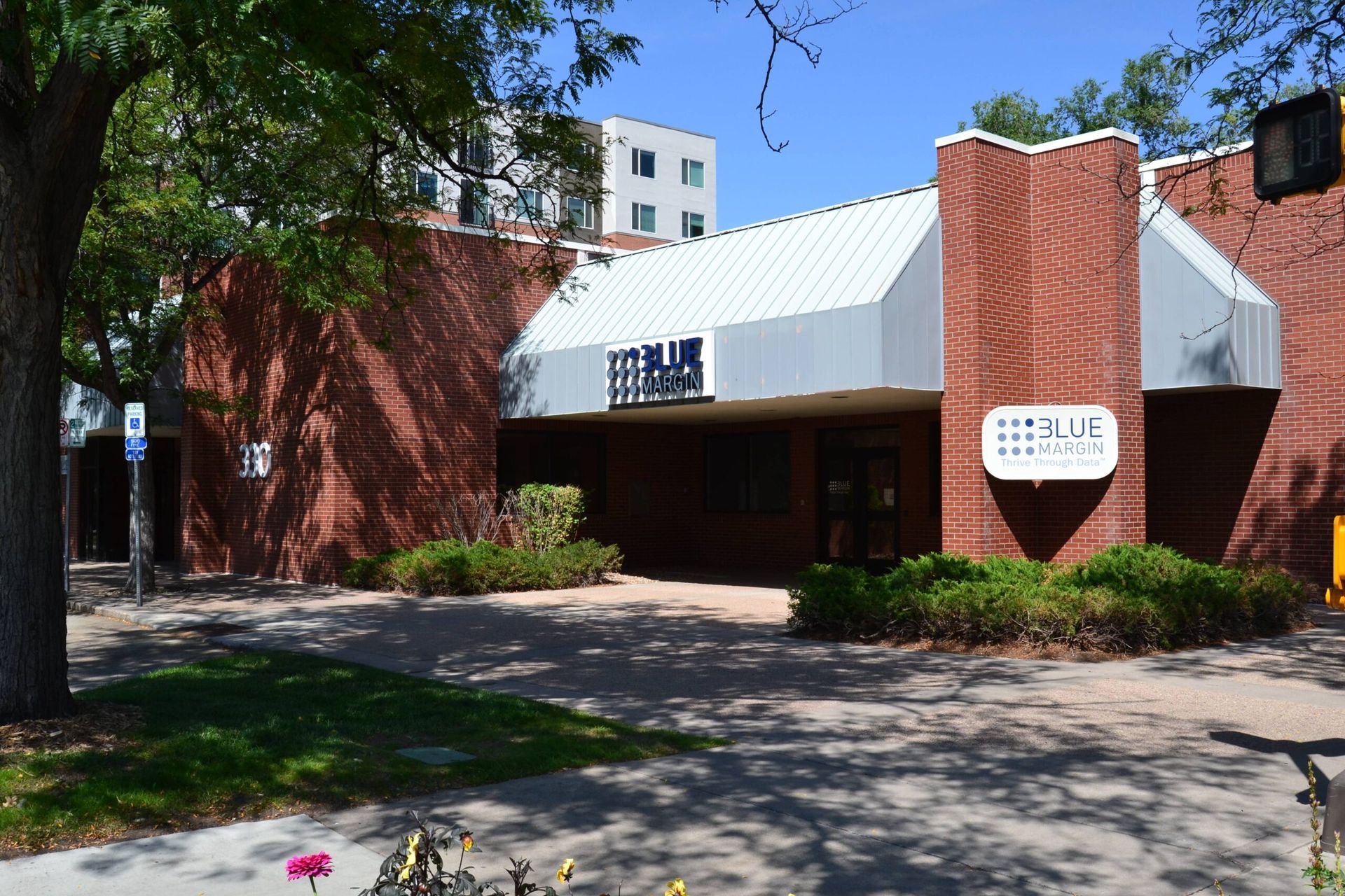 A brick building with a white awning and a sign that says hello