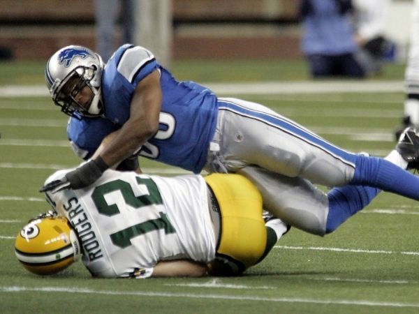 Landon Johnson making a tackle on a Green Bay Packer as a linebacker for the Lions