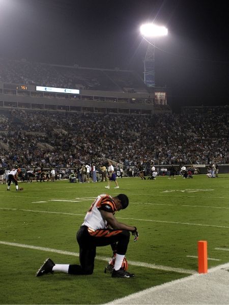 Landon Johnson taking a knee on the football field