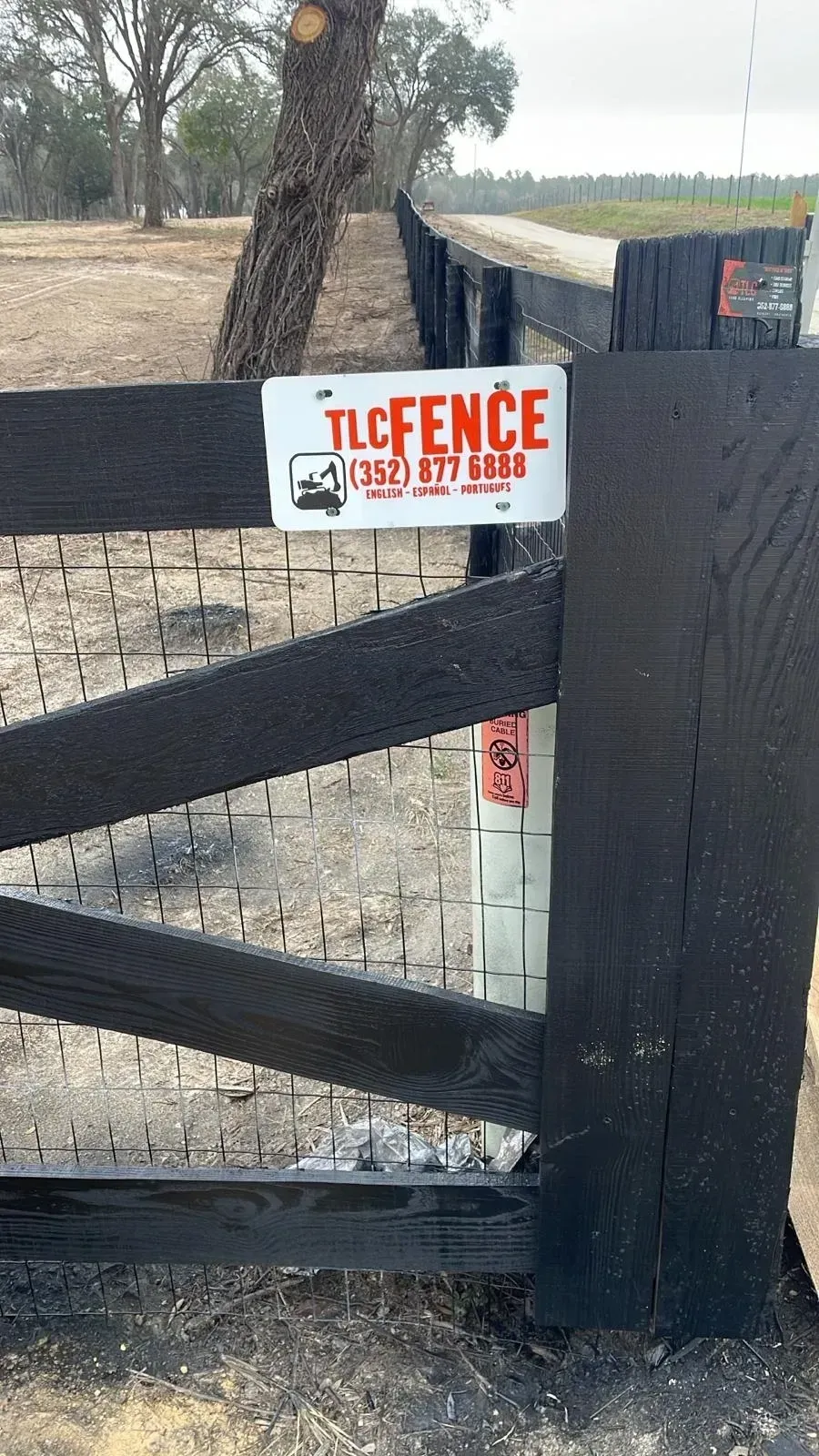 Black wooden gate with a white 