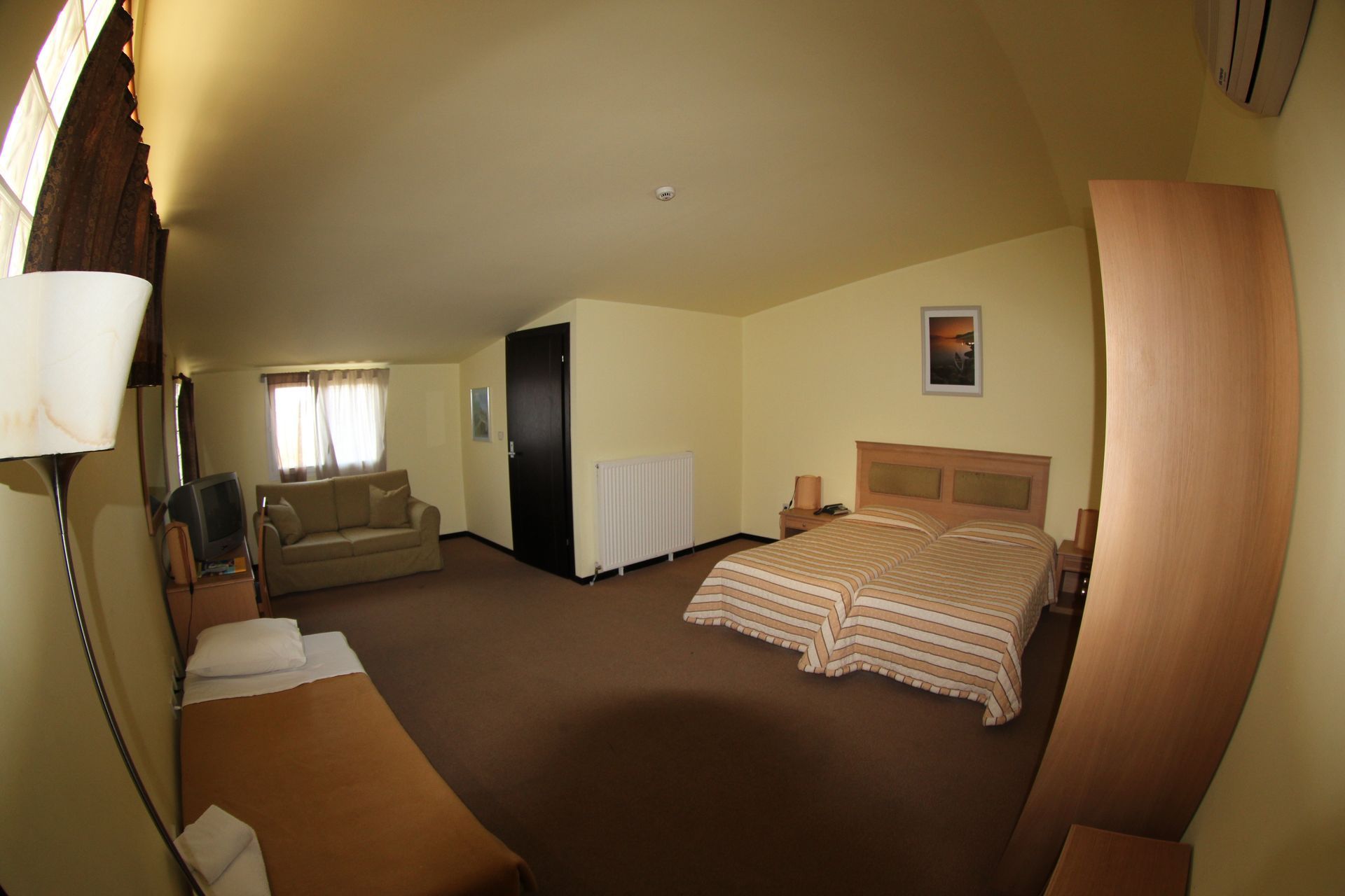 A hotel room with two beds and a couch