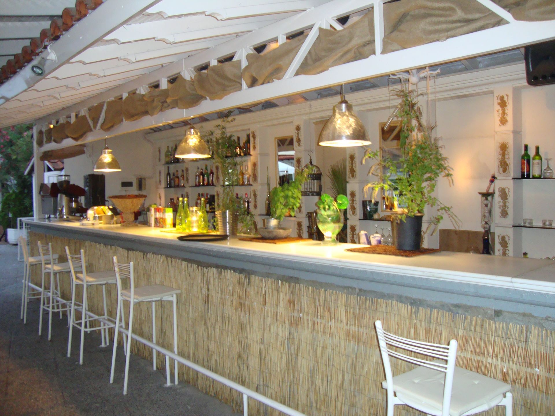 A restaurant with a long bar and stools
