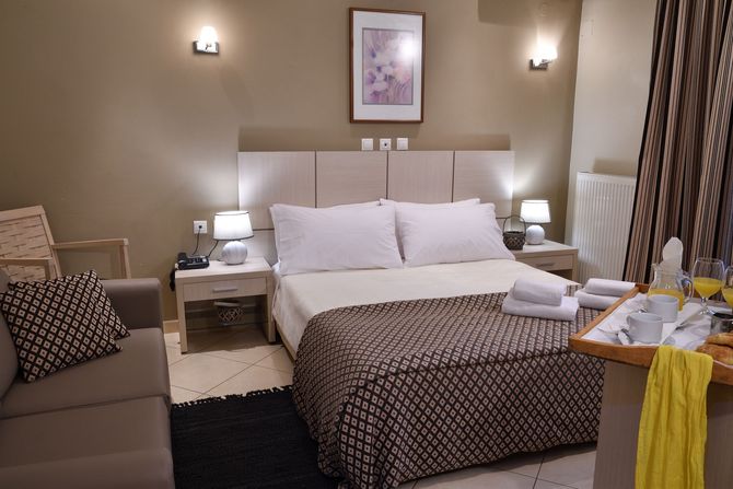 A hotel room with a large bed and a couch