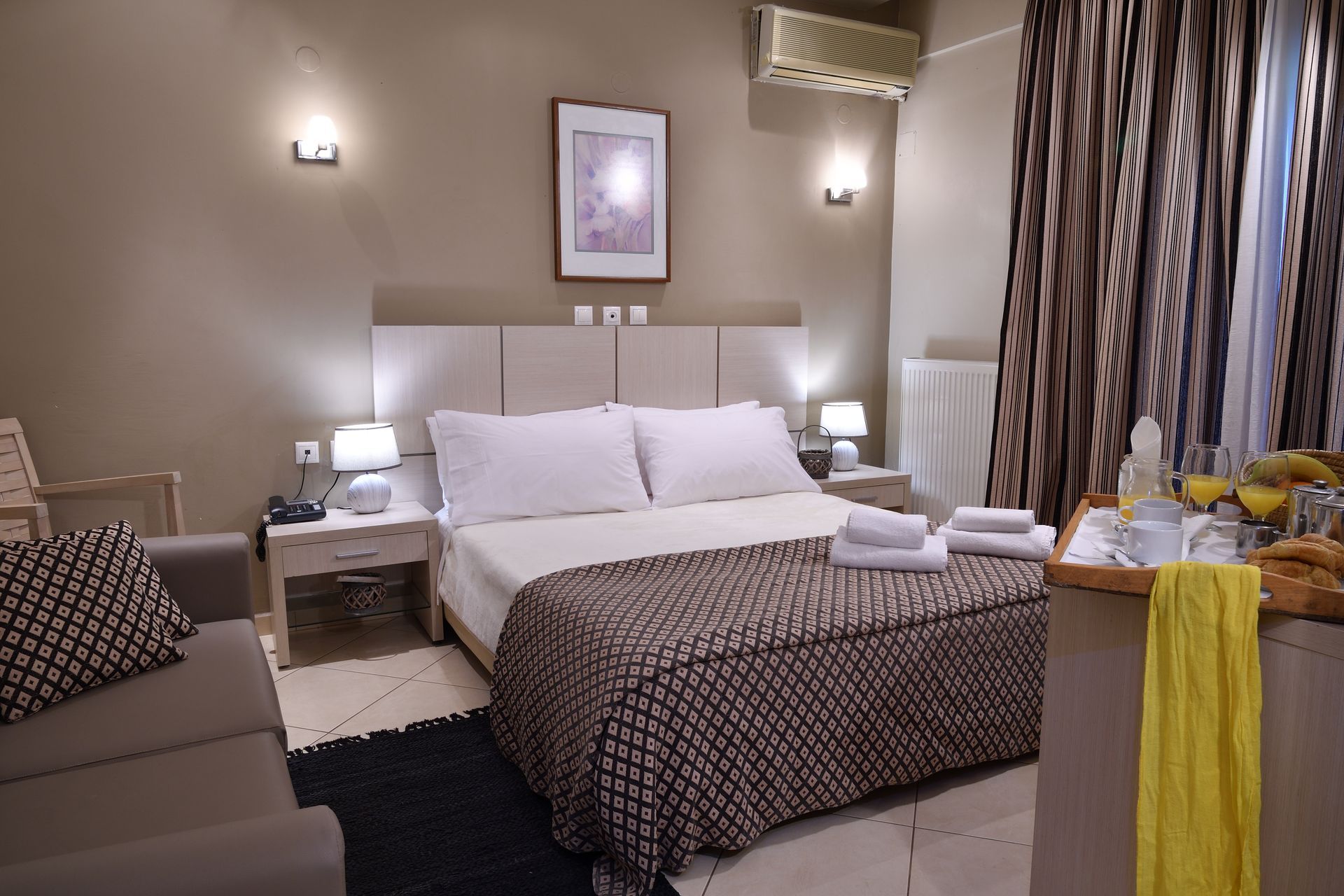 A hotel room with a large bed and a couch