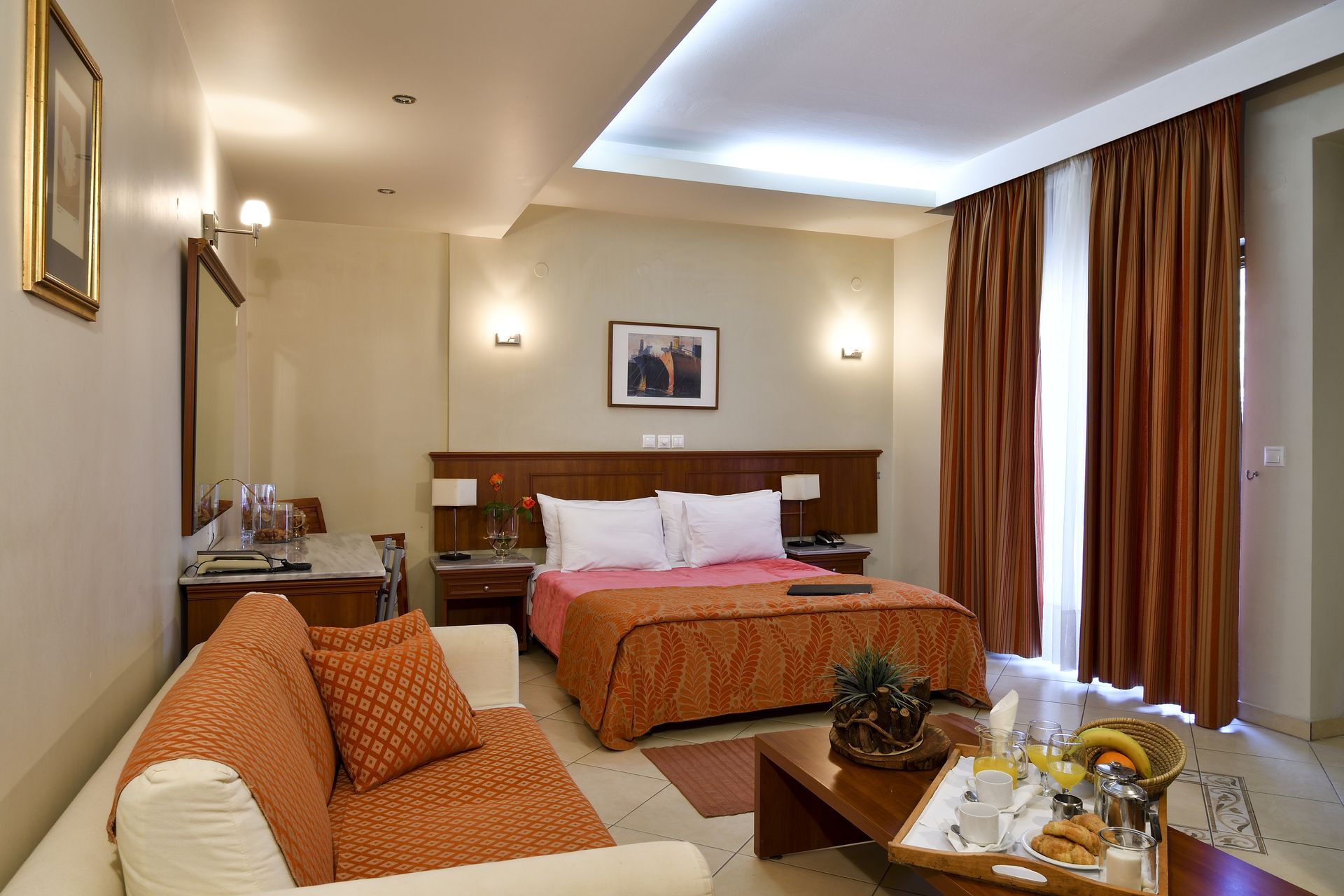 A hotel room with a couch and a bed