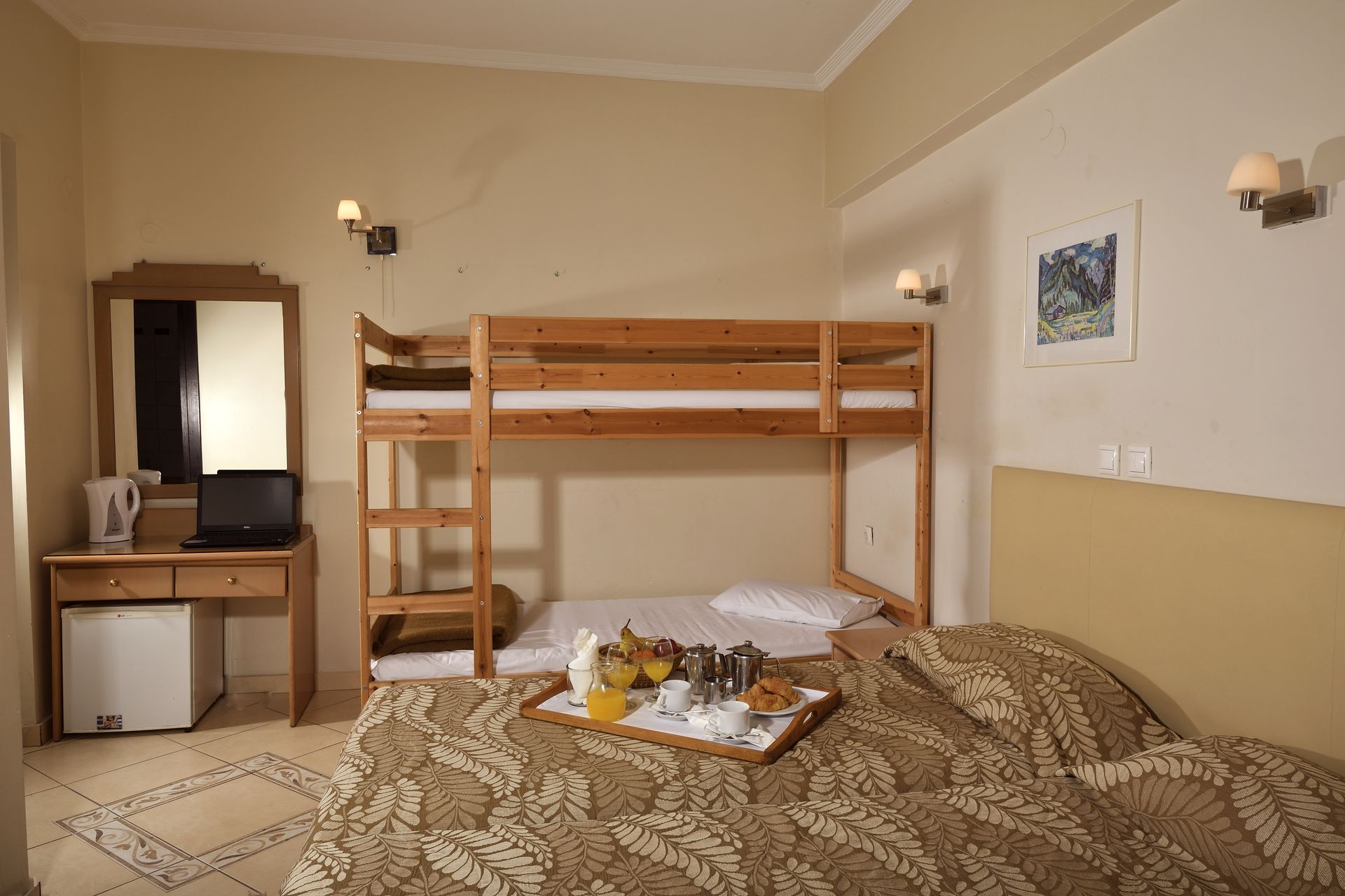 A hotel room with a bunk bed and a tray of food on the bed.