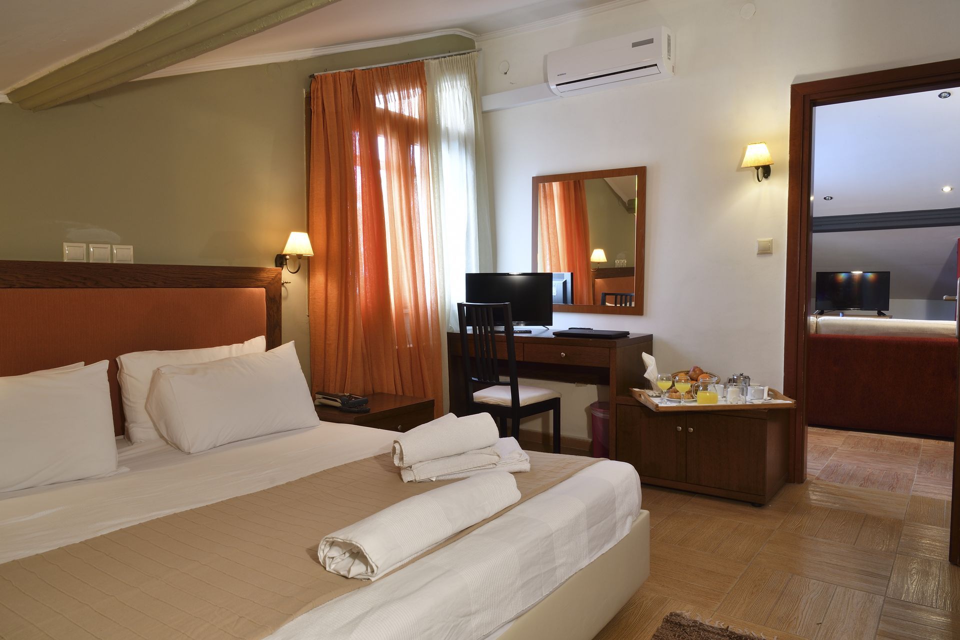A hotel room with a king size bed and a desk