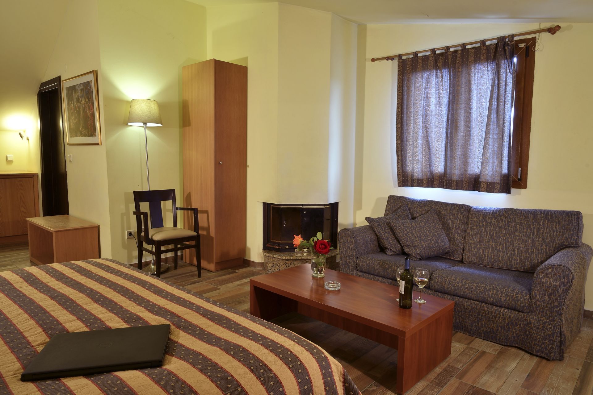 A bedroom with a bed a couch and a coffee table