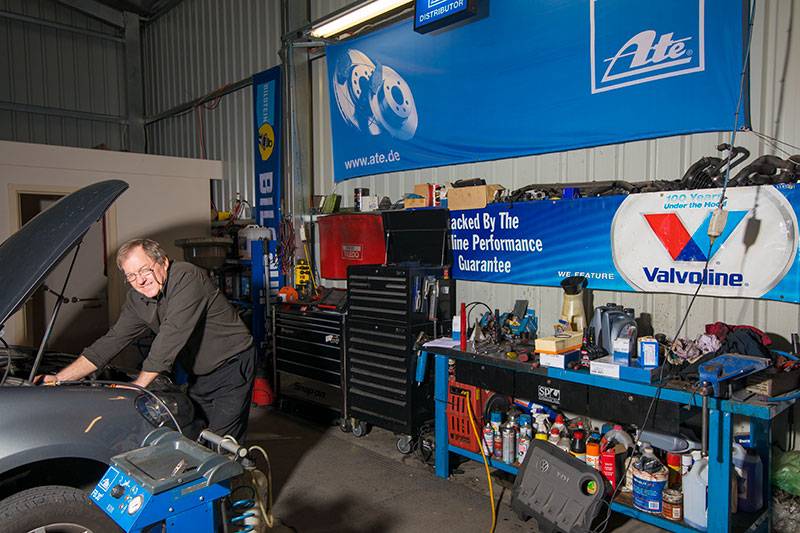 Mechanic looking at car engine