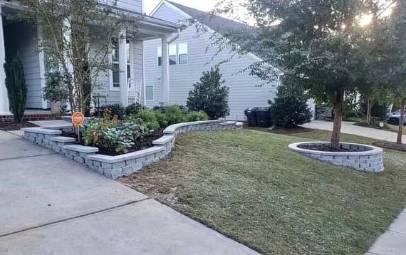 A house with a front yard featuring retaining walls and landscaping.