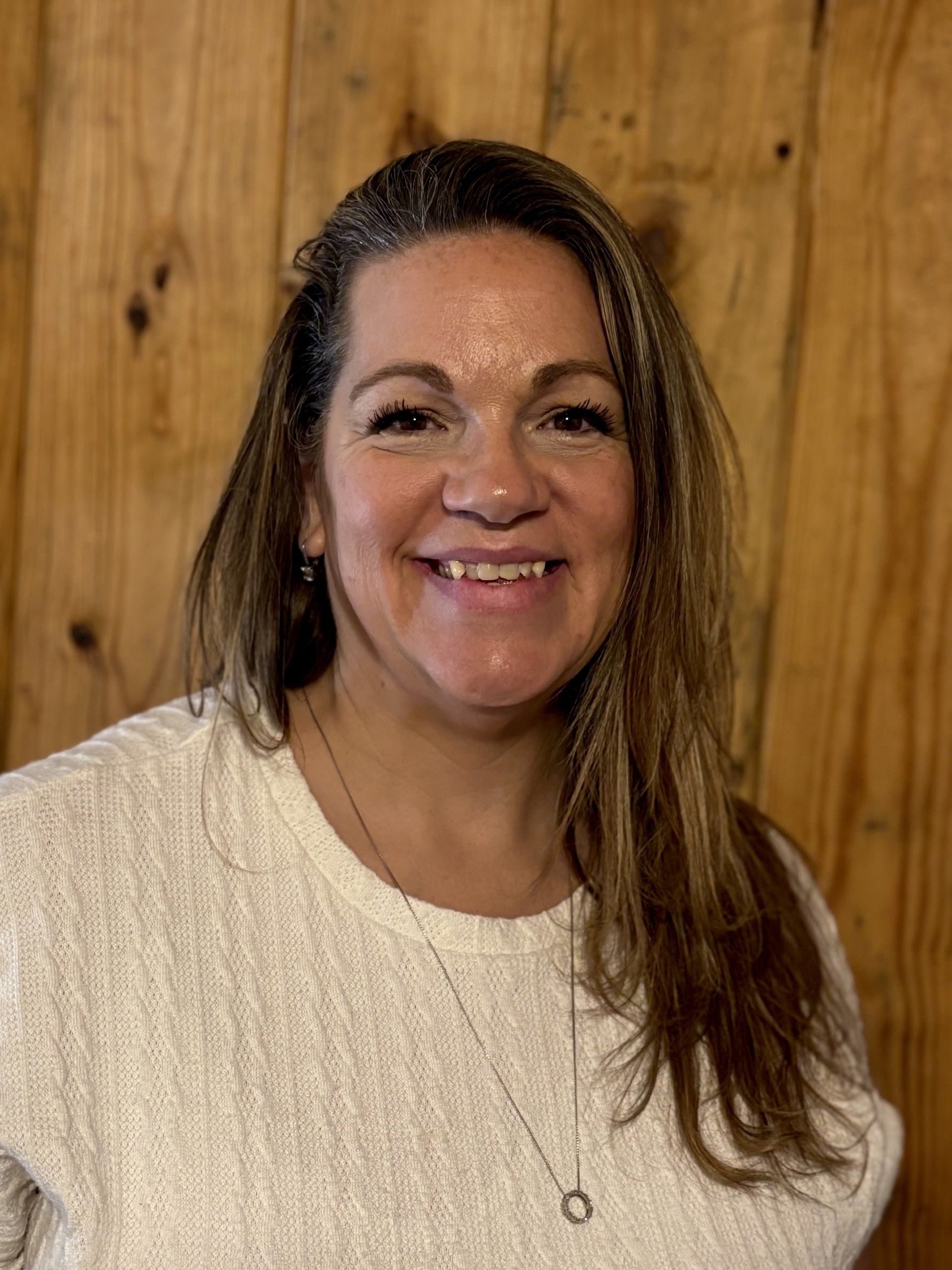 white female with brown hair smiling at the camera