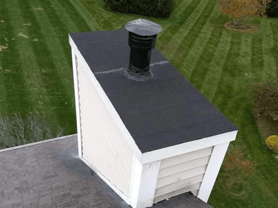 An aerial view of a roof with a chimney on top of it.