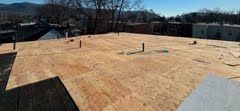 A wooden roof is being built on top of a building.