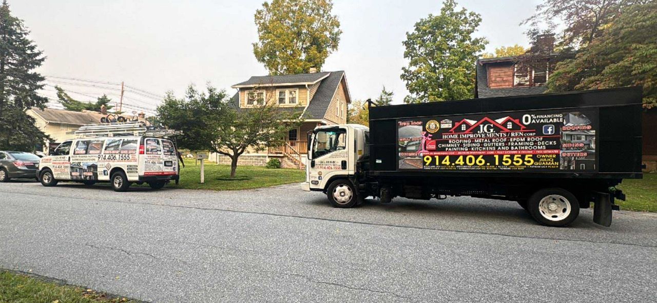 Two trucks on a residential street. One is an ice cream truck, the other a business truck with a phone number.