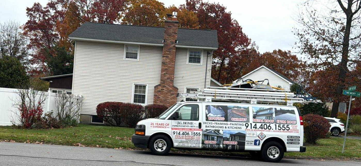 White van with roofing company logo parked in front of a house with a chimney and fall foliage.