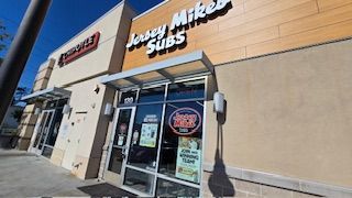 Jersey Mike's Subs storefront in a strip mall, with a Chipotle next door.