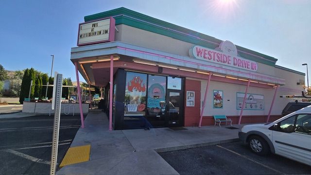 Westside Diner exterior with pink trim, sign, and a parked car on a sunny day.