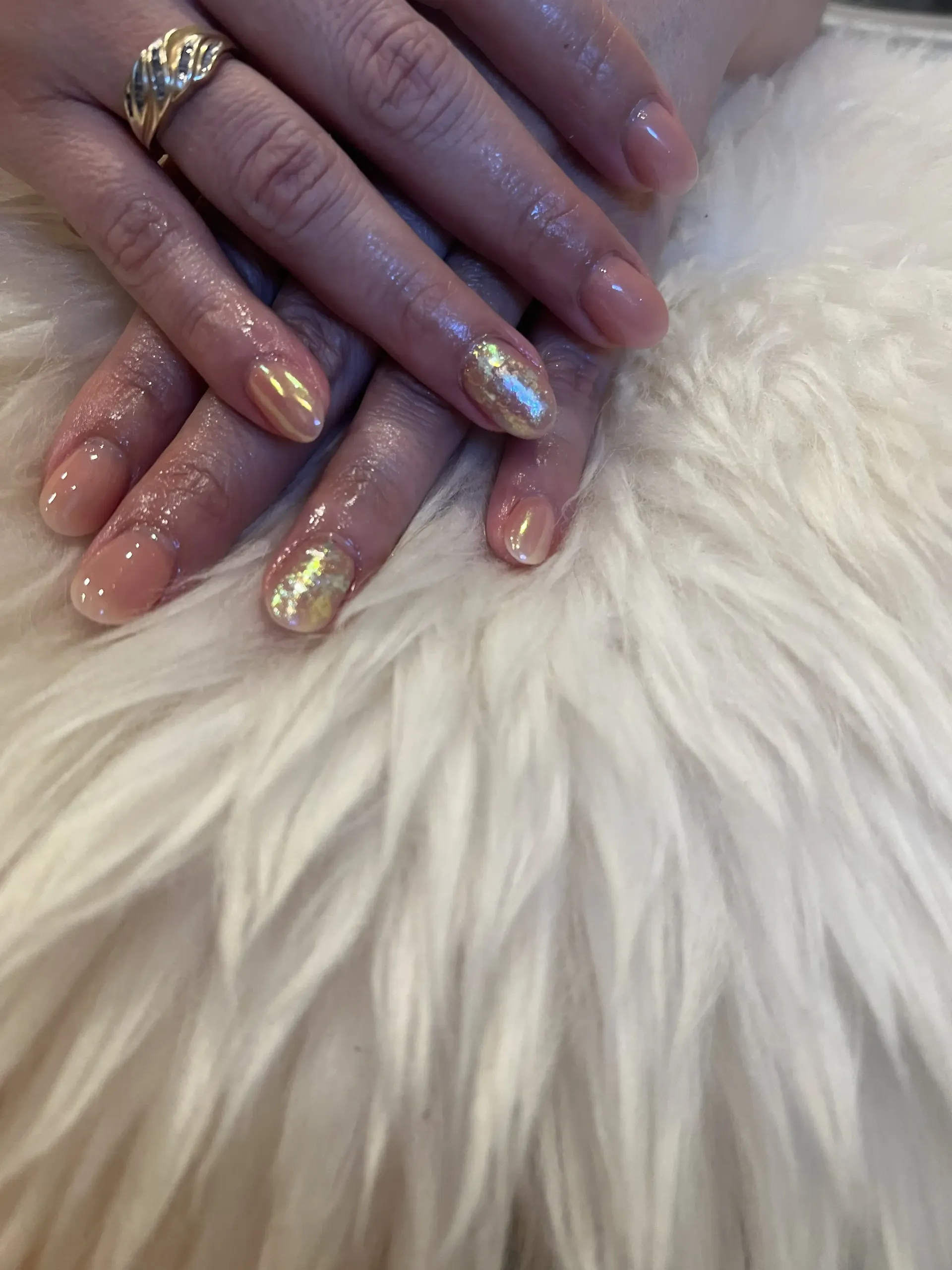 A close up of a woman 's nails with a ring on her finger.