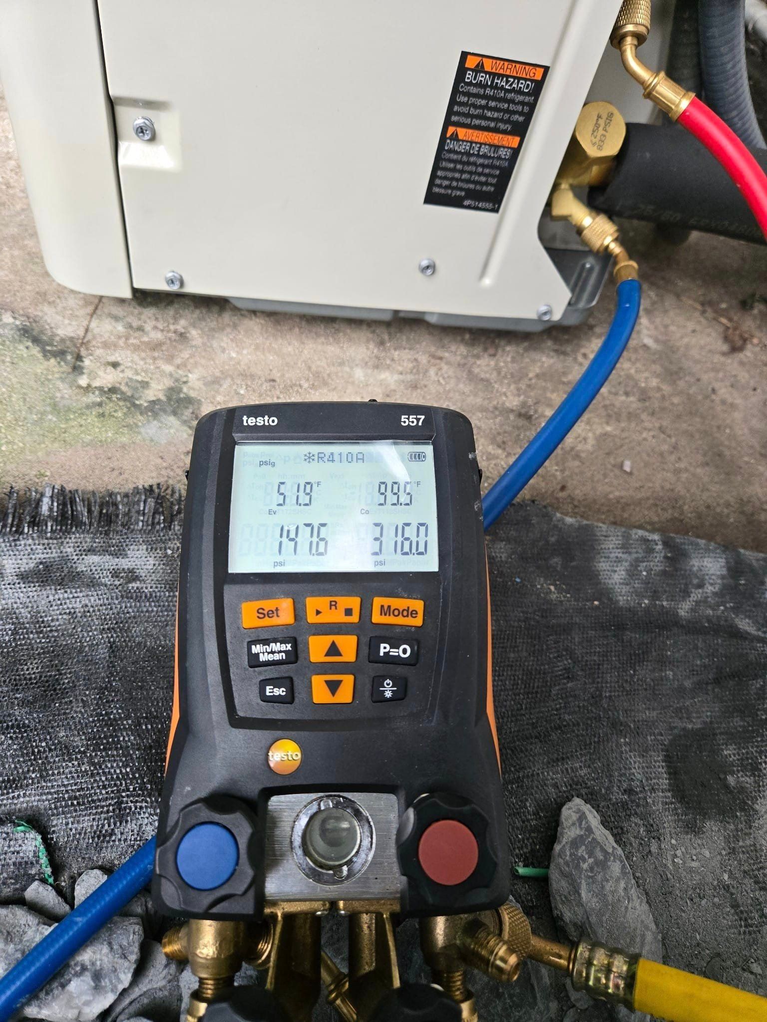 A digital thermometer is being used to measure the temperature of a refrigerator.