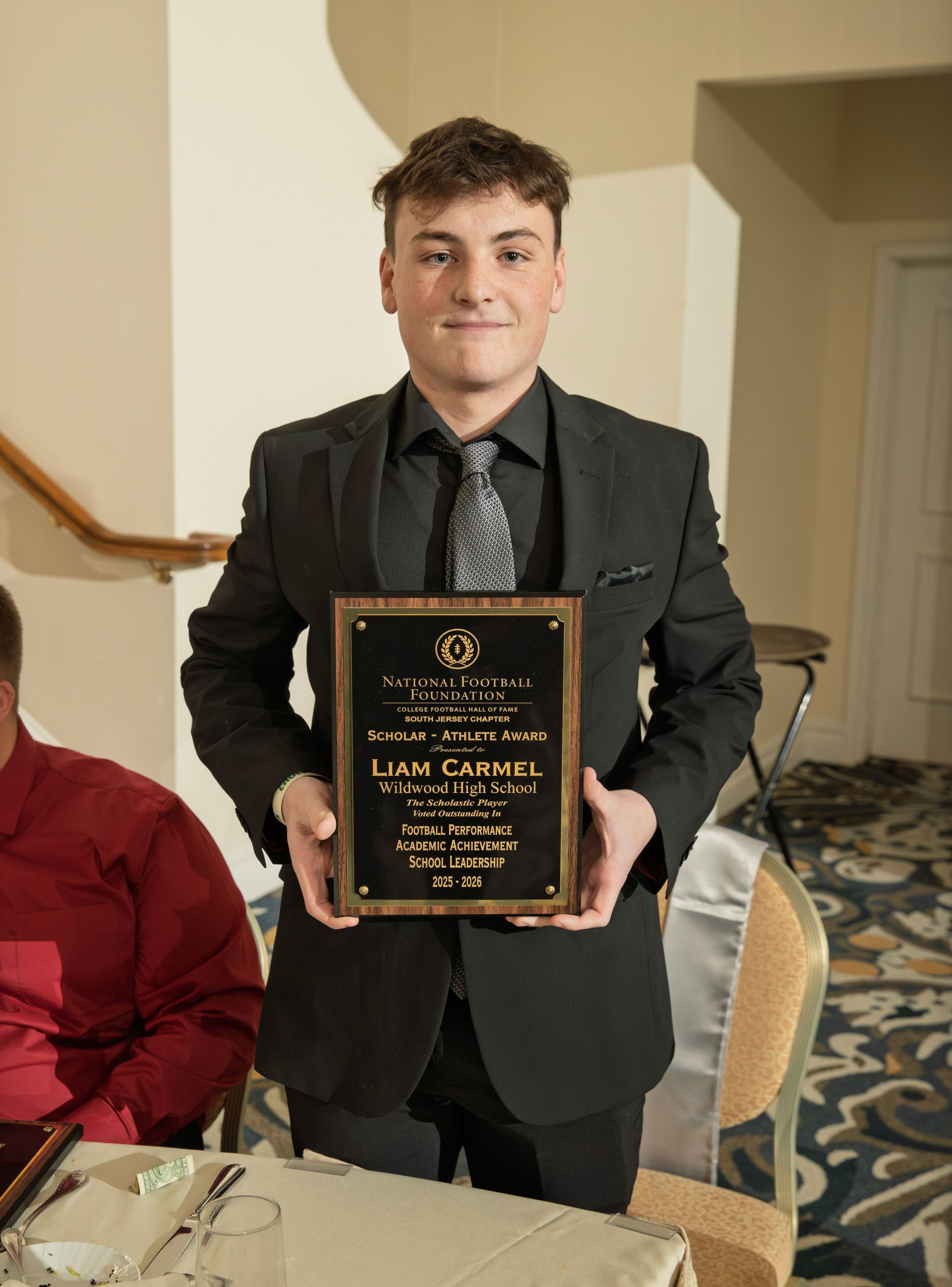 Liam Carmel from Wildwood High School holding scholar-athlete awards plaque from NFFSJ
