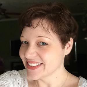 A woman with short hair is smiling for the camera.