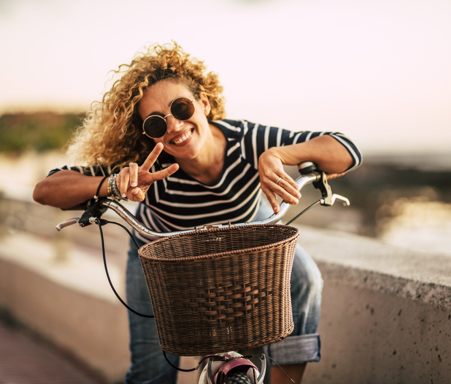 woman on bike with peace sign hands