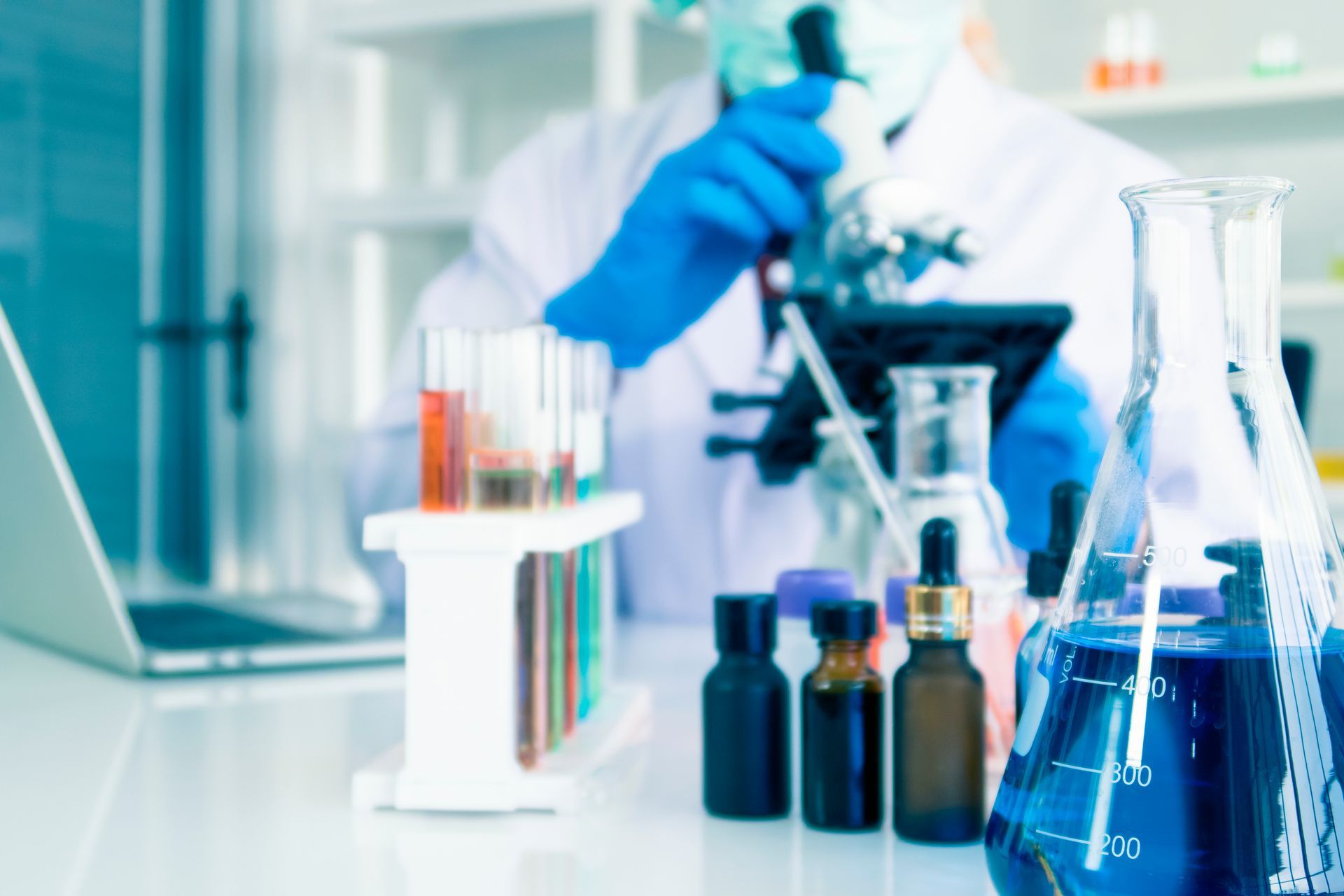 a scientist is looking through a microscope in a laboratory practicing green chemistry