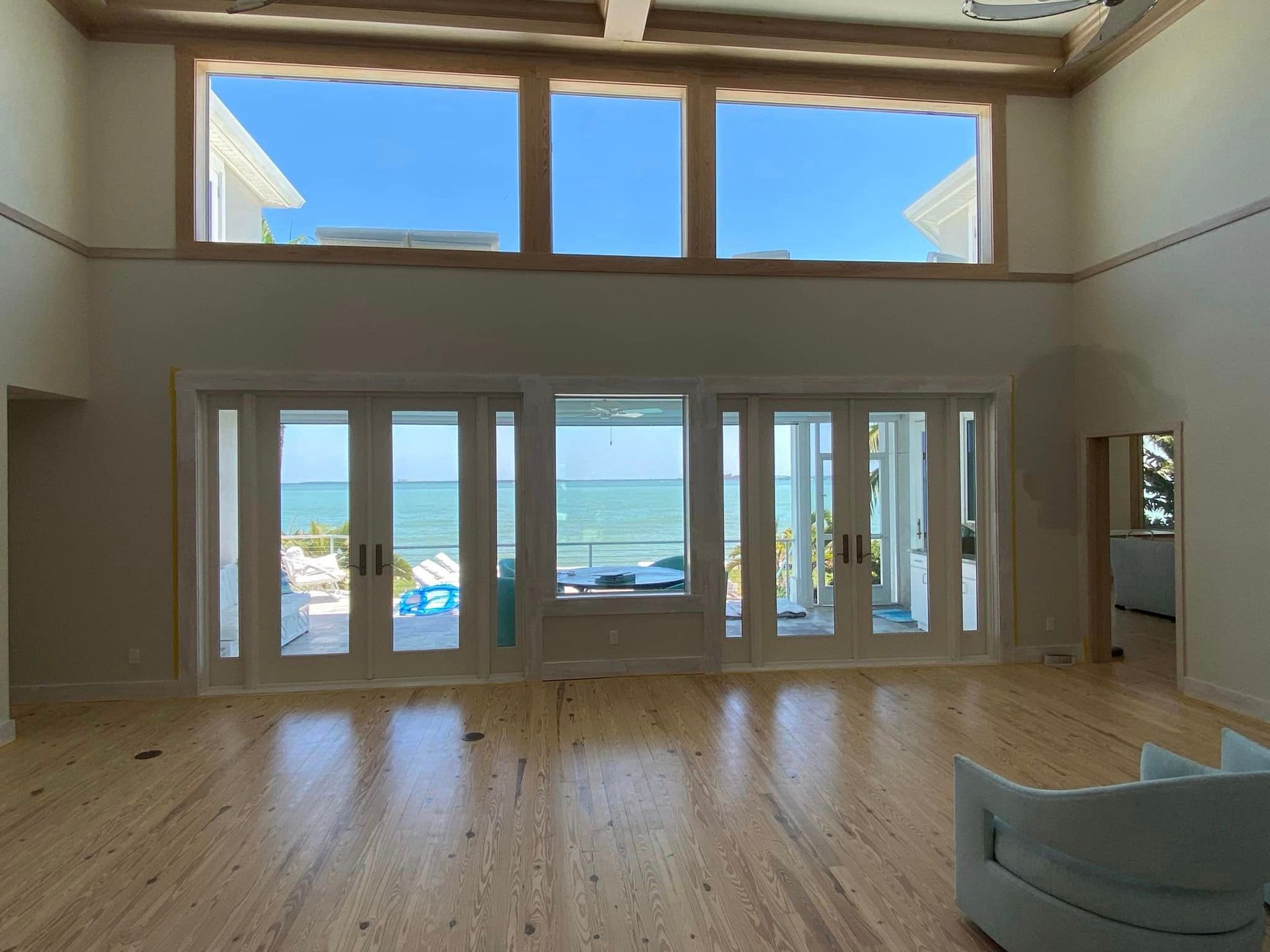 An empty living room with a view of the ocean