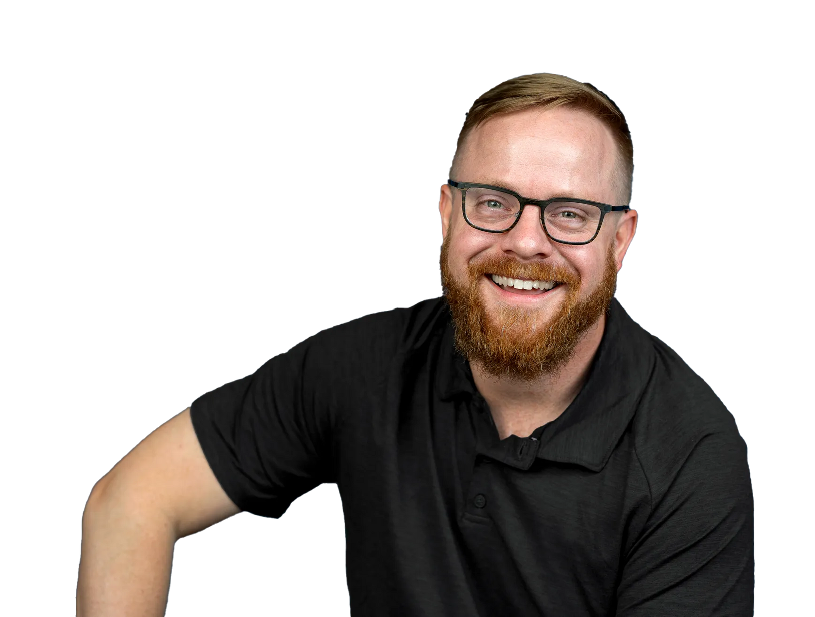 A man with a beard and glasses is wearing a black shirt and smiling.