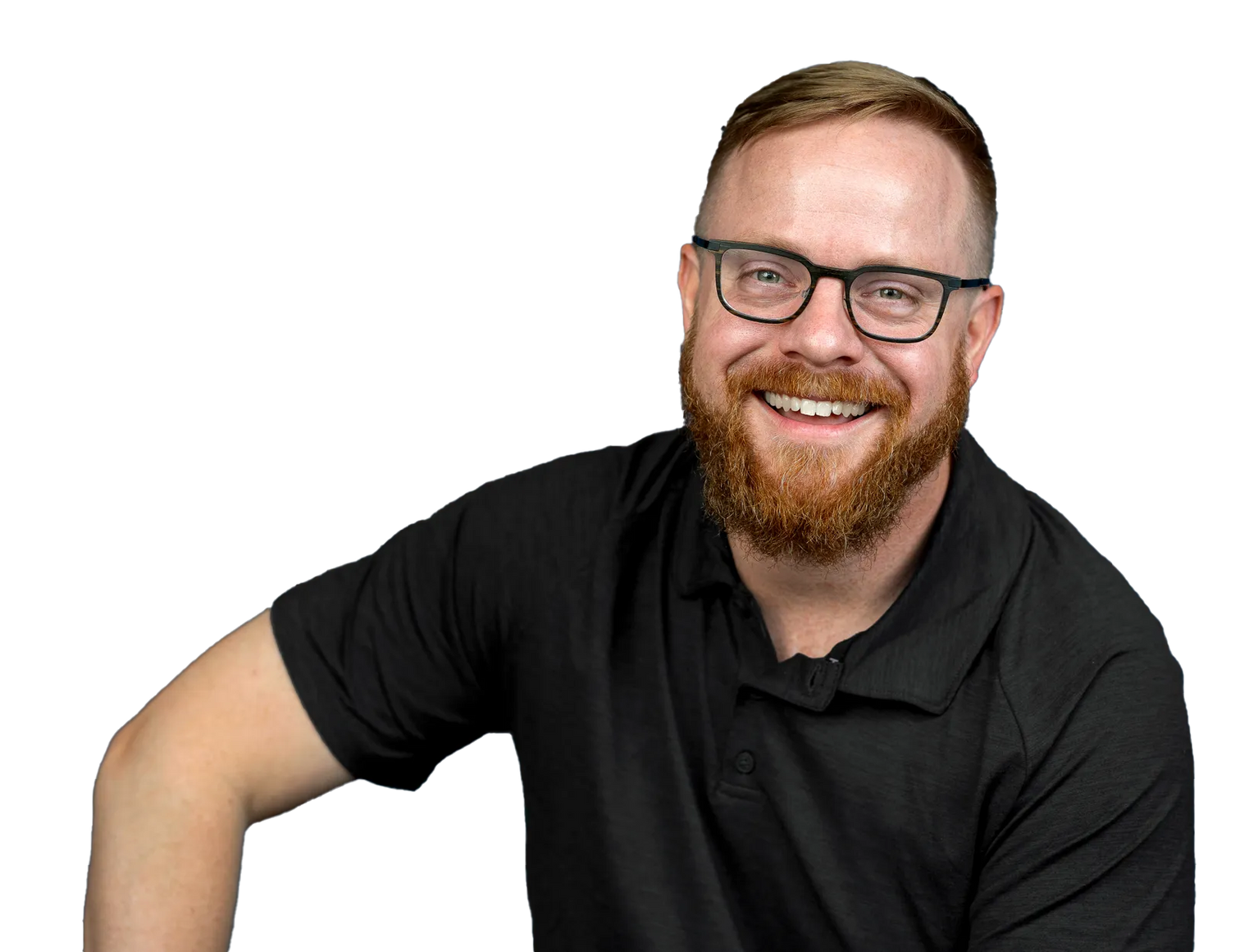 A man with a beard and glasses is wearing a black shirt and smiling.