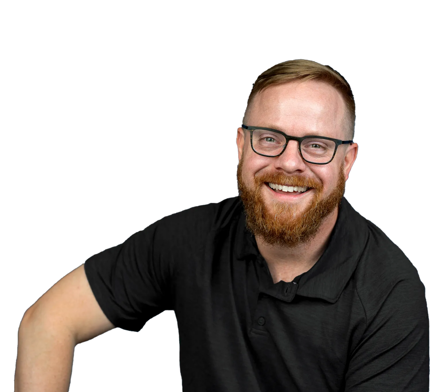 A man with a beard and glasses is wearing a black shirt and smiling.