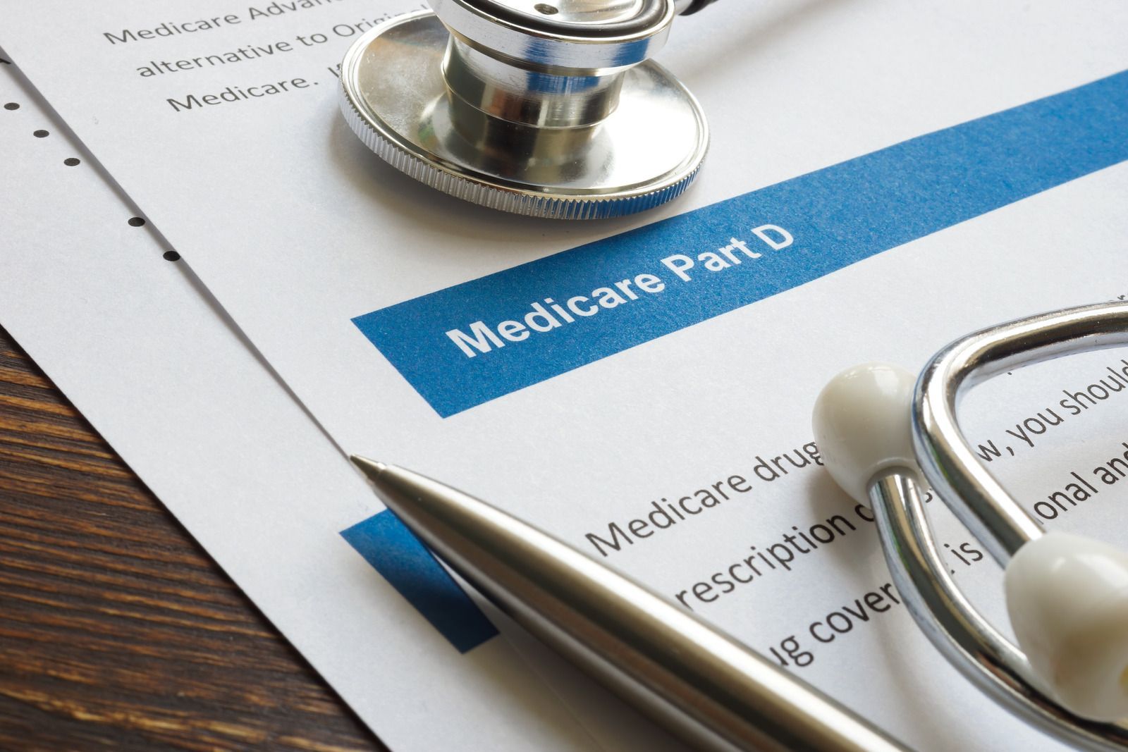 Medicare card and stethoscope on paperwork, suggesting healthcare insurance and medical records