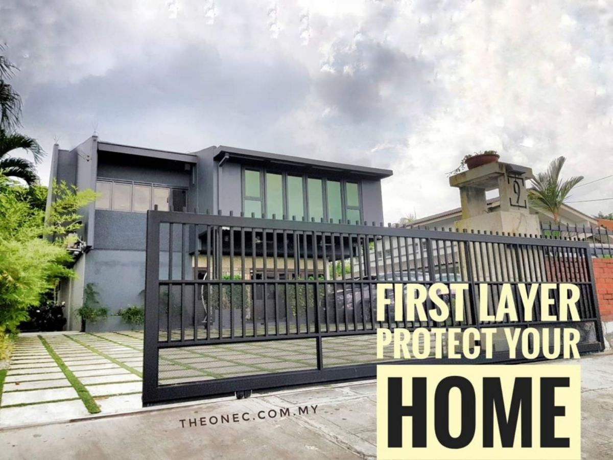 A large black vertical-slat sliding autogate in front of a modern grey two-story house