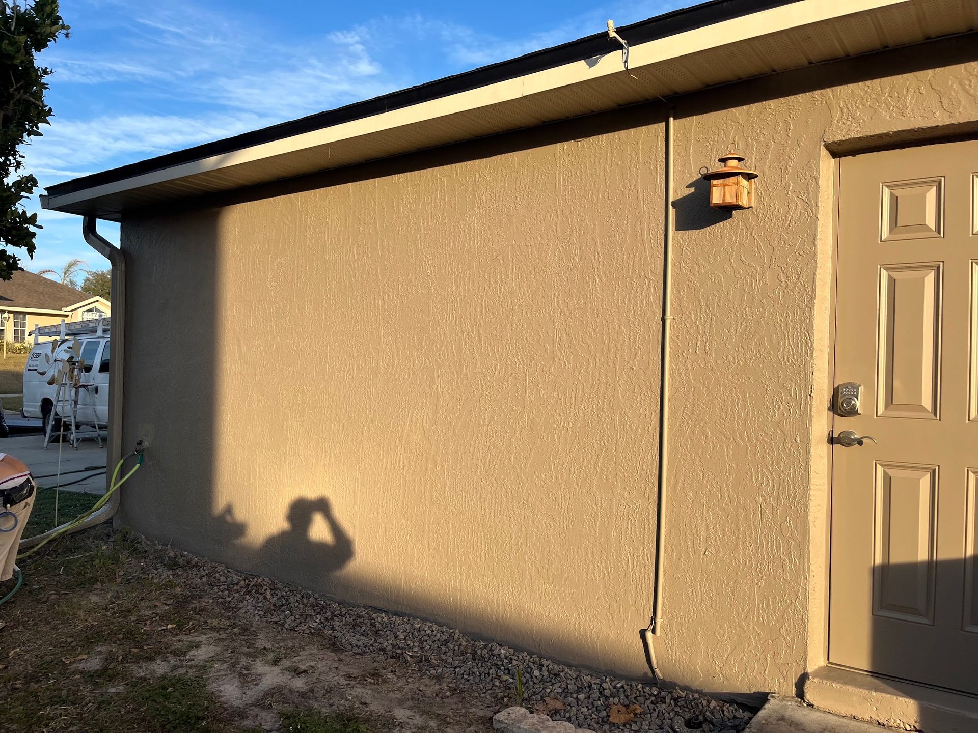 A house with a door and a light on the side of it.
