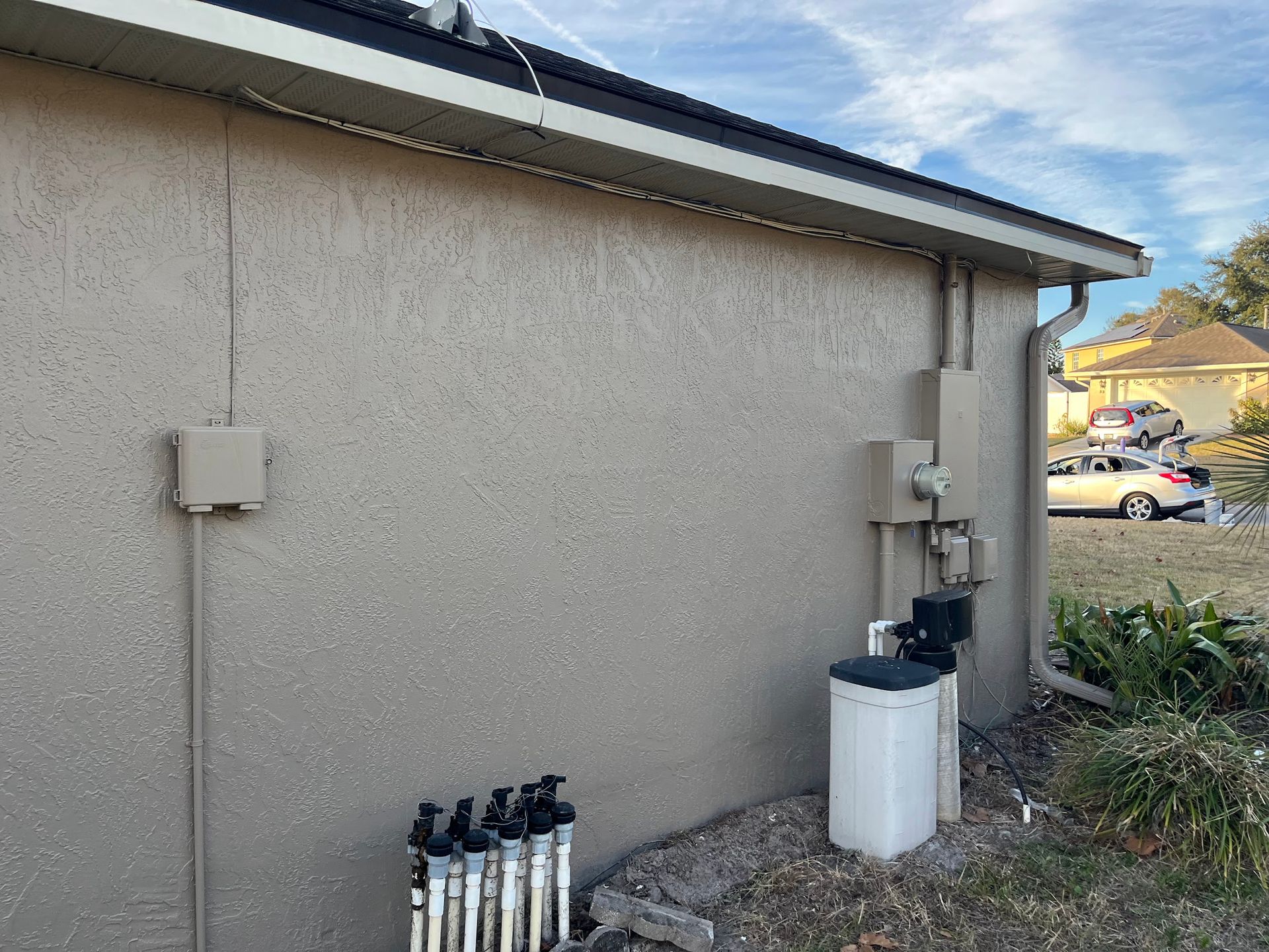 A house with a sprinkler system on the side of it.