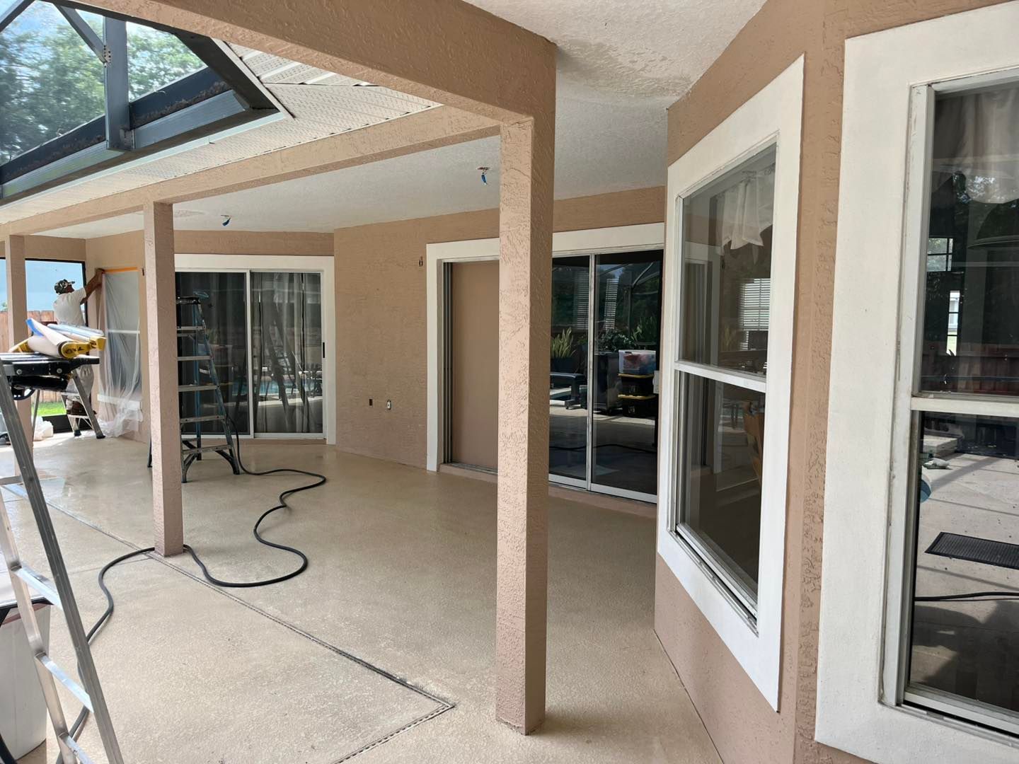A large room with a lot of windows and a sliding glass door.