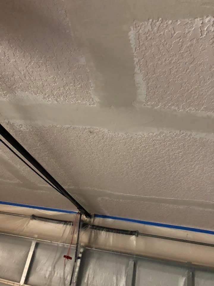 A person is plastering a wall with a spatula.