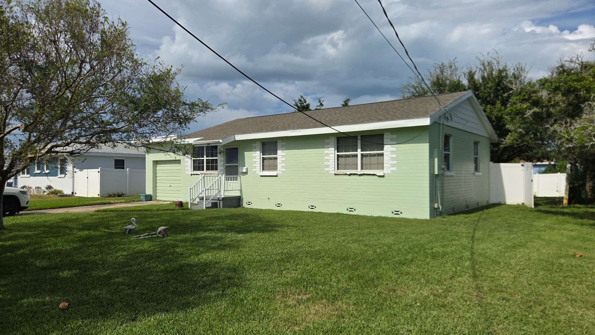 A picture of a house after being painted white.