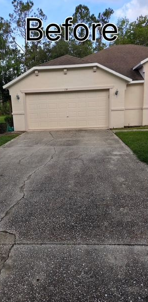 A before picture of a house with a red garage door.